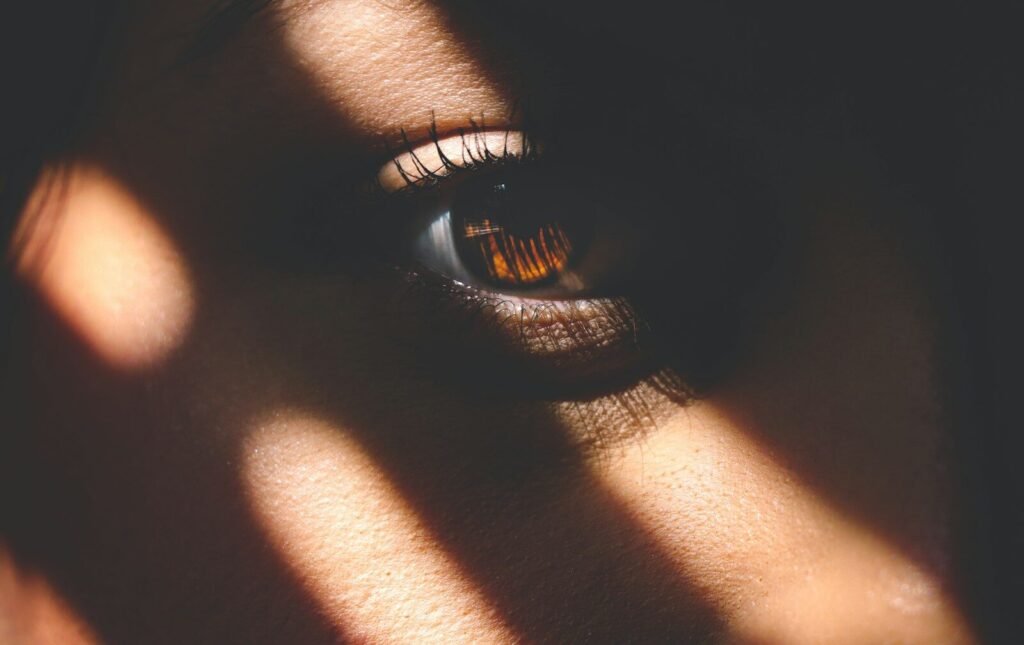 a close up of a person's eye with a shadow