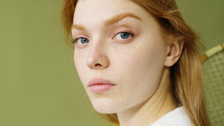 Detailed close-up portrait capturing a young woman's natural beauty and blue eyes.